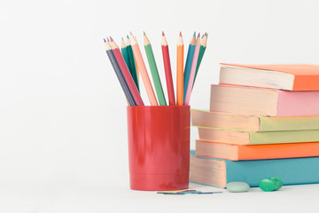 Stacks of Books with cup of colored pencils